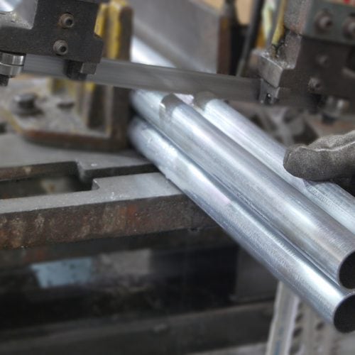 Close up of metric aluminum tube being cut for shipment