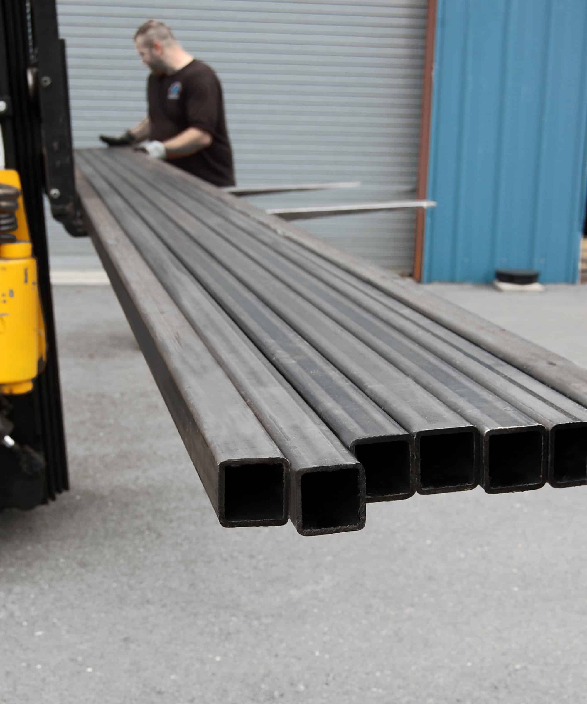 Metric metal square tube being loaded onto fork lift